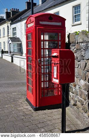 Glenarm, Uk- May 29, 2022: A Red Uk Phone And Post Box On A Street In Glenarm