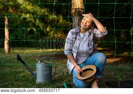 Delightful Young Woman Farmer Amateur, Admiring Beautiful Sunset In The Eco Farm. Sunbeams Falling O