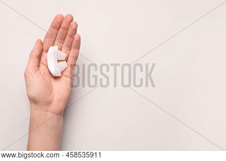 Woman Holding Anti-snoring Device On Light Grey Background, Top View. Space For Text