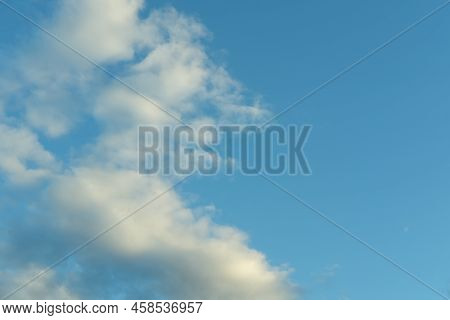 Blue Sky Background With White Fluffy Cumulus Clouds. Panorama Of White Fluffy Clouds In The Blue Sk