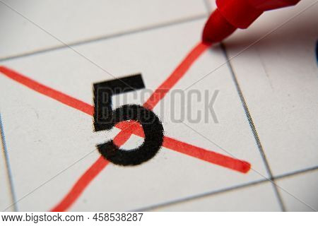 The 5st Number In The Calendar Is Crossed Out With A Red Cross In A Macro On A White Sheet. Calendar