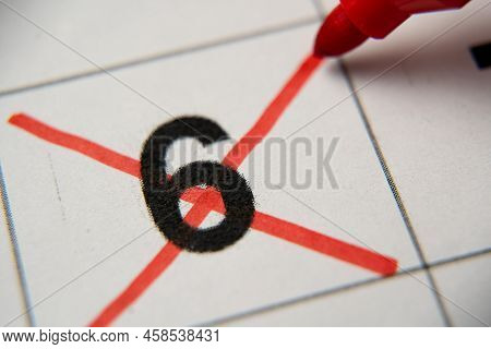 The 6st Number In The Calendar Is Crossed Out With A Red Cross In A Macro On A White Sheet. Calendar