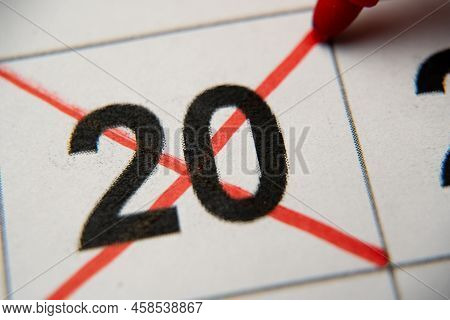 The 20st Number In The Calendar Is Crossed Out With A Red Cross In A Macro On A White Sheet. Calenda