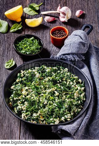 Spanakorizo, Greek Spinach And Rice Pilaf With Lemon, Dill, Spring Onion On Skillet On Dark Wooden T