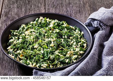 Spanakorizo, Greek Spinach And Rice Pilaf With Lemon, Dill, Spring Onion In Frying Pan On Dark Woode