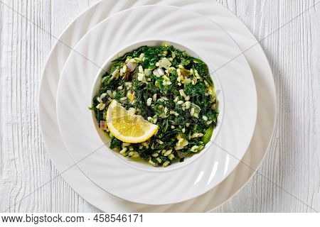 Spanakorizo, Greek Spinach And Rice Pilaf With Lemon, Dill, Spring Onion In White Bowl On White Text