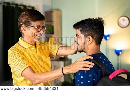 Happy Caring Grandfather Blessing School Going Grandson With Backback At Home - Concept Of Parental 