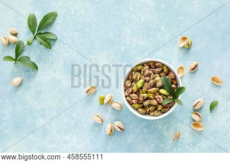 Pistachios. Whole Pistachios With Green Leaves And Pistachio Nut Kernels. Healthy Natural Vegetarian