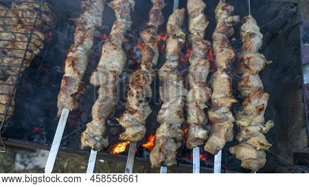 Selective Focus. Cooking Barbecue On The Mangal In Nature. Grilled Tasty Meet Cooking On The Party. 