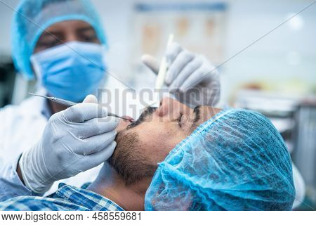 Focus On Patient Close Up Of Dentist Busy Operating Surgery At Hospital - Concept Of Dental Care, To