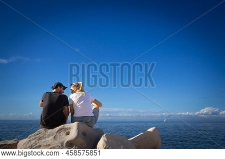 Piran, Slovenia - September 17, 2021: Selective Blur On A Young Couple, Lovers, Man And Woman, Looki