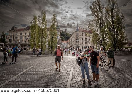Ljubljana, Slovenia - June 14, 2021: Selective Blur On Two Tourists Taking A Selfie Picture In Front