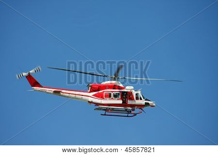 Patrol Helicopter Of Firefighters In Blue Sky Over A Fire 8