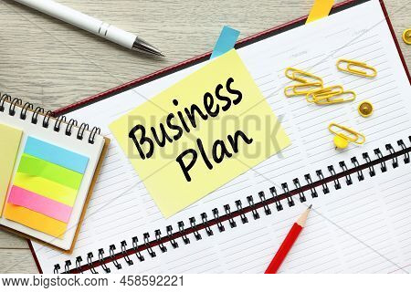 Business Plan Inscription On A Yellow Sticker. On The Diary