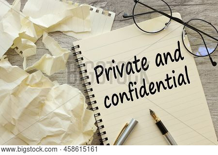 Private And Confidential Text In Pen. On A Beautiful Notebook With Glasses