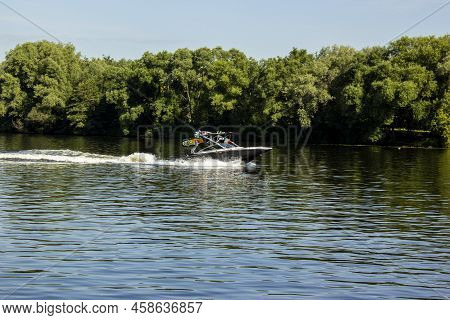 Modern Speedboat Sailing On Forest Background. Summer Leisure And Water Activity. Rest On The River 