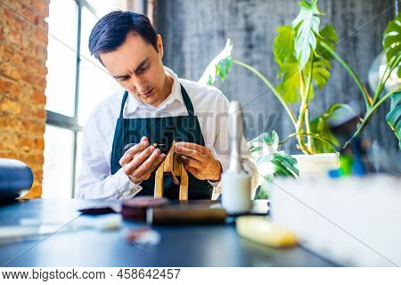 Hobby Became A Small Business Leather Man In Apron Is Making A Leather Wallet And Shooes In Studio