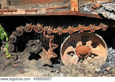 A Fragment Of A Caterpillar Of A Burnt And Charred Tank. A Blown Up And Burnt Tank At The Front. War