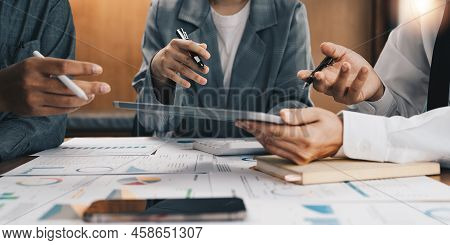 Business Team Meeting And Discussing Project Plan. Businessmen Discussing Together In Meeting Room. 