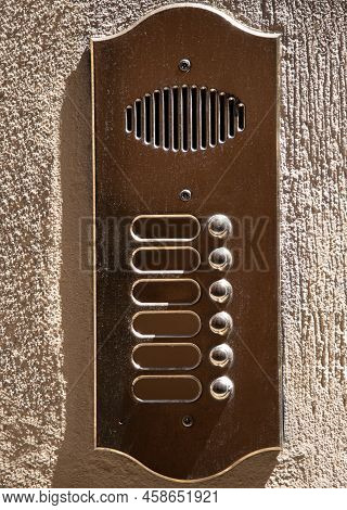 Weathered Brass Panel With Six Doorbells And Speaker