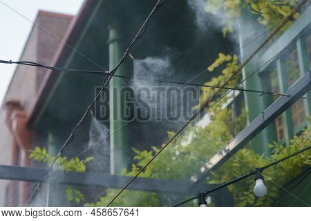 Fogging Outdoor Cool Misting System Working Hot Summer Day For Terrace In Cafe. Facility That Lowers