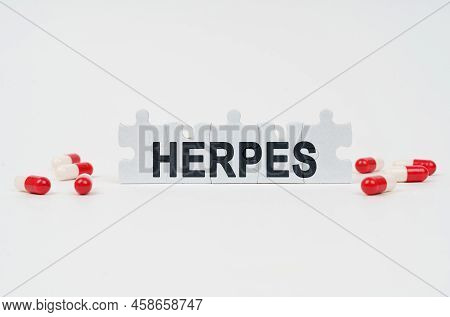 Medical Concept. On A White Surface Are Tablets And Puzzles With The Inscription - Herpes