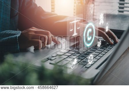 Copyright Or Patent Concept, Person Hand Using Laptop Computer On Desk With Vr Screen Copyright Icon
