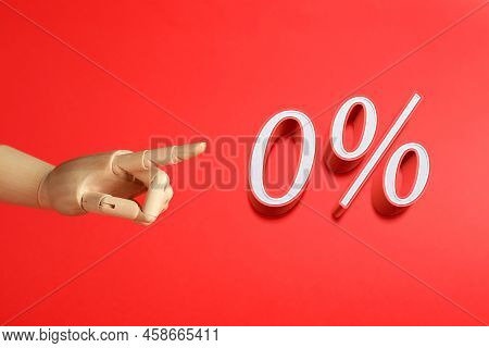 Wooden Mannequin Hand Pointing At Sign Of Zero Percent On Red Background. Special Promotion