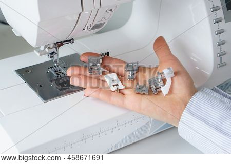 Seamstress Holds Sewing Machine Parts In Hands. Presser Foot Accessories In Tailor Hand. Dressmaker 