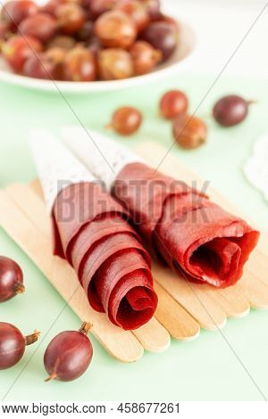 Handmade Berries Pastille Rolls On Kitchen. Dry Vegan Snack Made Of Red Gooseberry. Healthy Raw Sour