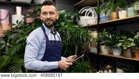 Businessman Owner Of A Flower Shop Holding A Banzai In His Hands With A Smile