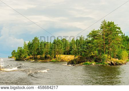 North Karelia Lake, Russian Wild Nature. Forest Growing On The Stones