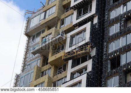 The Developer Insulates The Facade Of A House Under Construction With Mineral Insulation Around The 