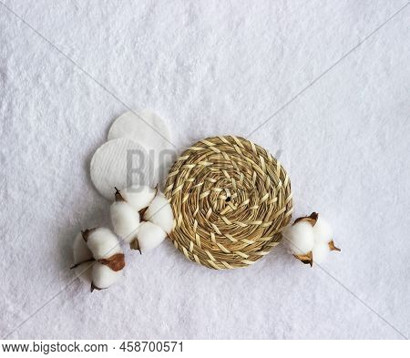 Cotton Pads With Cotton Flower Laying On The White Towel