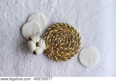 Cotton Pads With Cotton Flower Laying On The White Towel