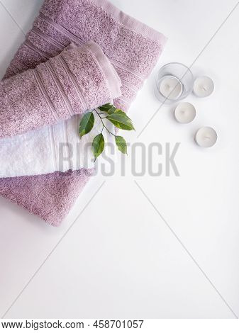 Pink And White Towels With Little White Candles On The White Background