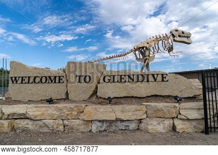 Glendive, Montana - July 22, 2022: Welcome To Glendive Sign Features A Dinosaur Skeleton, As The Tow