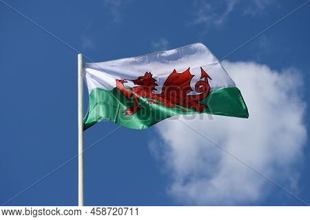 Wales Flag - Red Dragon Passant On White And Green - Bold And Proud Floating In The Wind Against Blu