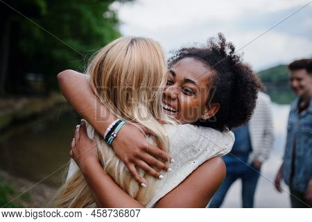 Friends Having Fun Together At Park Lauging And Hugging, Friendship And Lifestyle Concepts