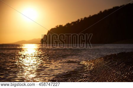 Beautiful Sea Wave Washes Pebbles On The Shore In Blur.