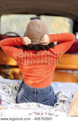 Rear View Of Young Woman Traveler Sitting In Minivan At Campsite In Forest, Female Relaxing In Car T