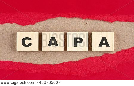 Capa Word On A Wooden Cubes On Red Torn Paper , Financial Concept Background