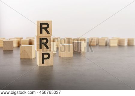 Rrp - Recommended Retail Price - Text As A Symbol On Cube Wooden Blocks. Many Wooden Blocks In The B