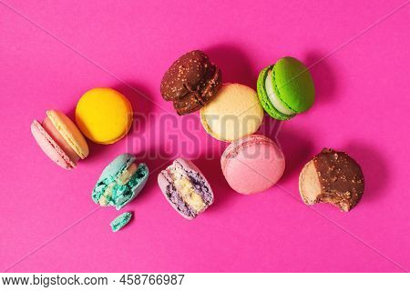 Bright Colorful Various Flavor Macarons Sweet Cookies On High-colored Pink Background.