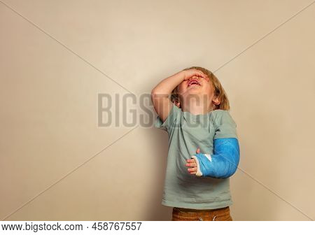 Crying Boy With Broken Hand Stand Over Wall