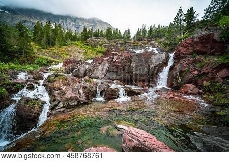 Redrock Falls Waterfall In Glacier National Park Along The Swiftcurrent Pass Trail