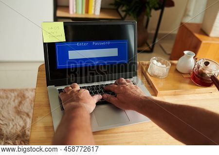 Hands Of Senior Man Entering Password To Get Access To His Laptop