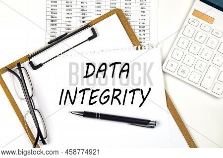 Text Data Integrity On White Paper On Clipboard With Chart And Calculator
