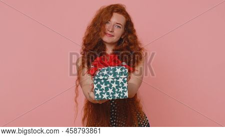 Smiling Redhead Young Woman Presenting Birthday Gift Box Stretches Out Hands Offer Wrapped Present C