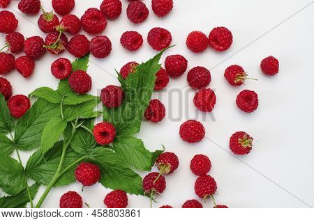 Ripe Juicy Fresh Raspberries With Green Leaf On White Background Flat Lay Top View. Raspberry Patter